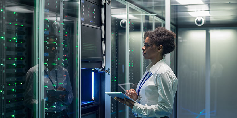 female-technician-works-on-a-tablet-in-a-data-center