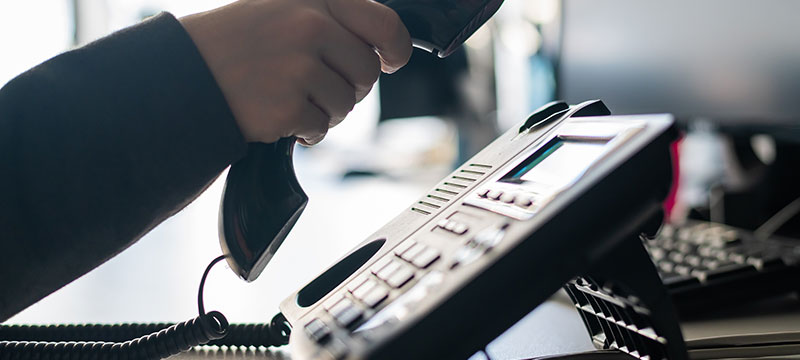 close-up-of-the-hand-of-a-female-office-worker-dialing-a-number-on-a-landline-phone-faceless-woman-secretary-calls-on-the-phone